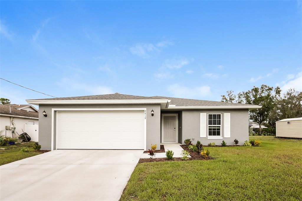 a front view of a house with a yard and garage