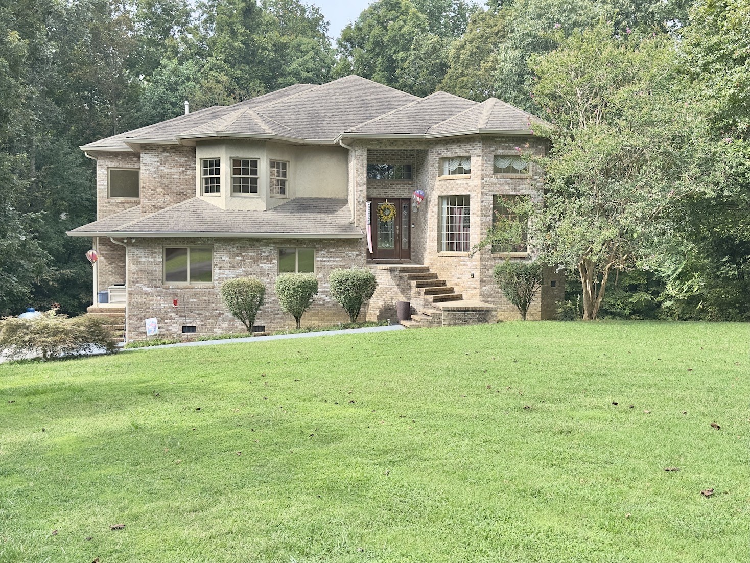 a front view of a house with a garden