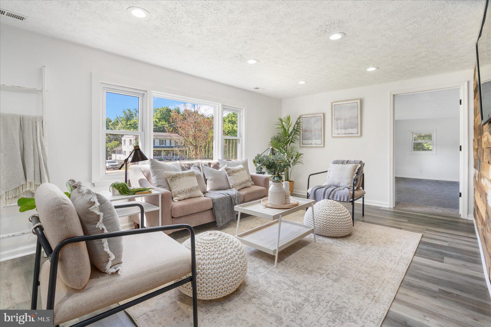 a living room with furniture and a large window