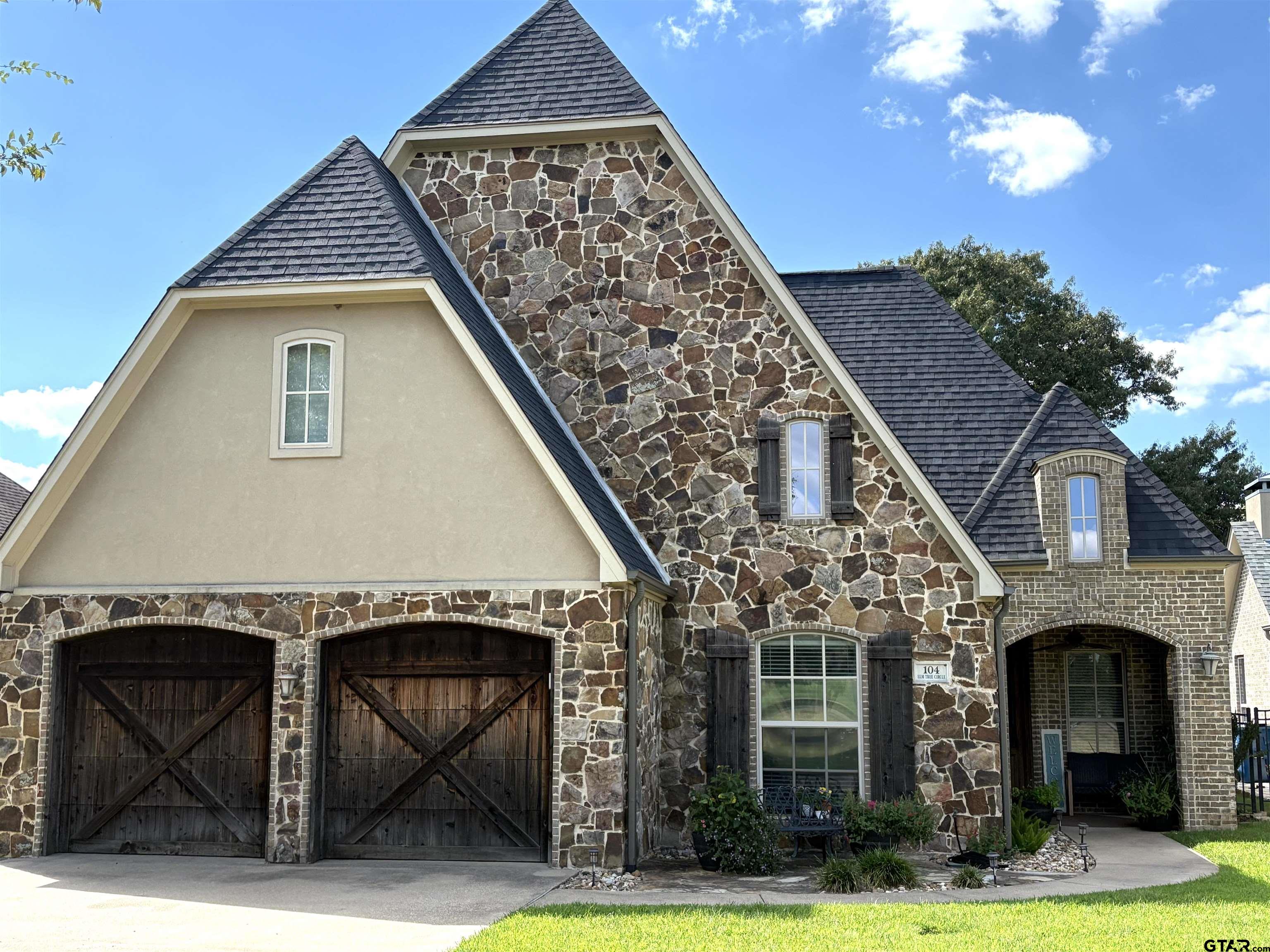 a front view of a house with garden