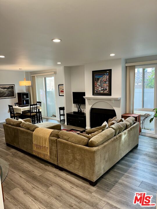 a living room with furniture a flat screen tv and a fireplace