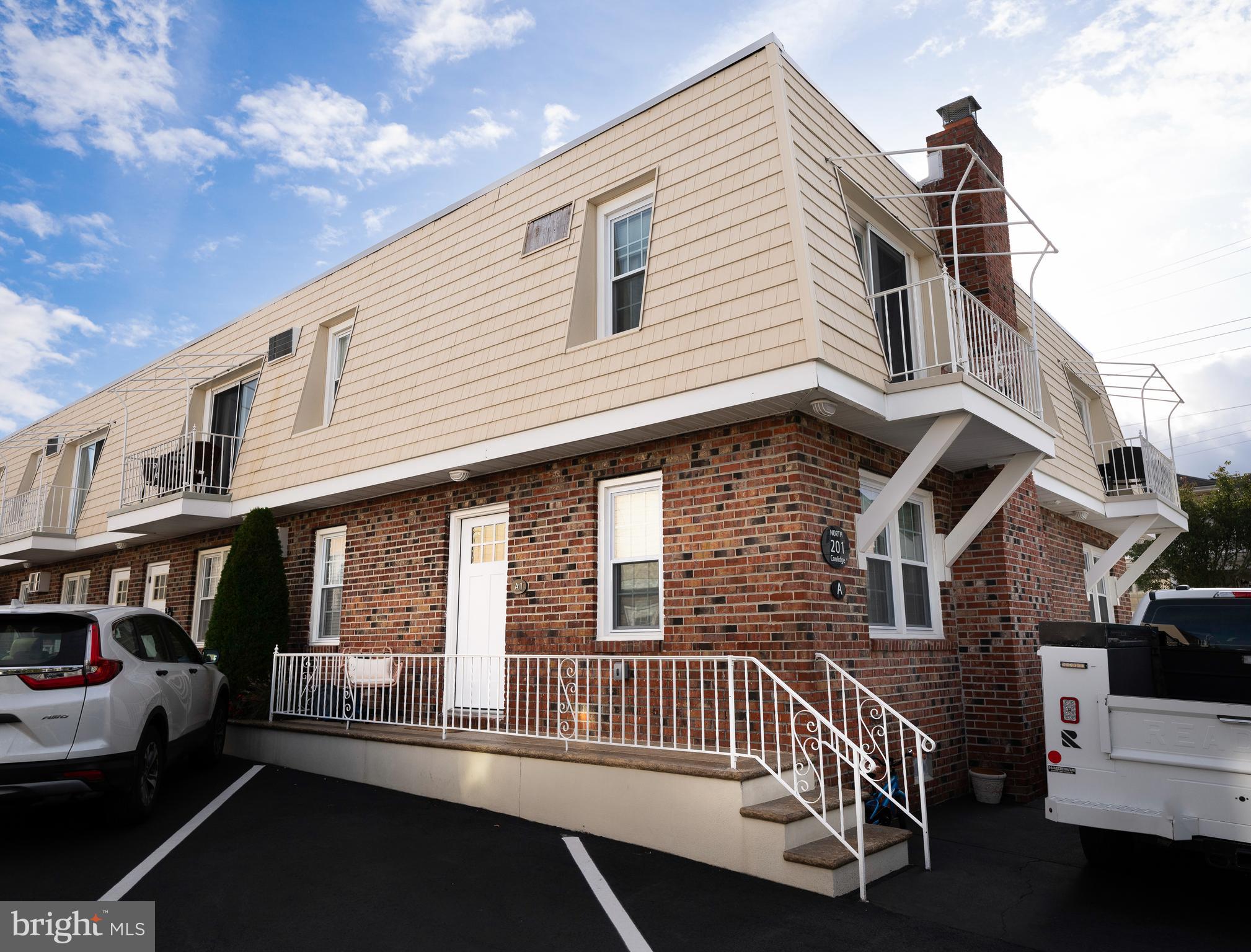 a view of a house with a small deck