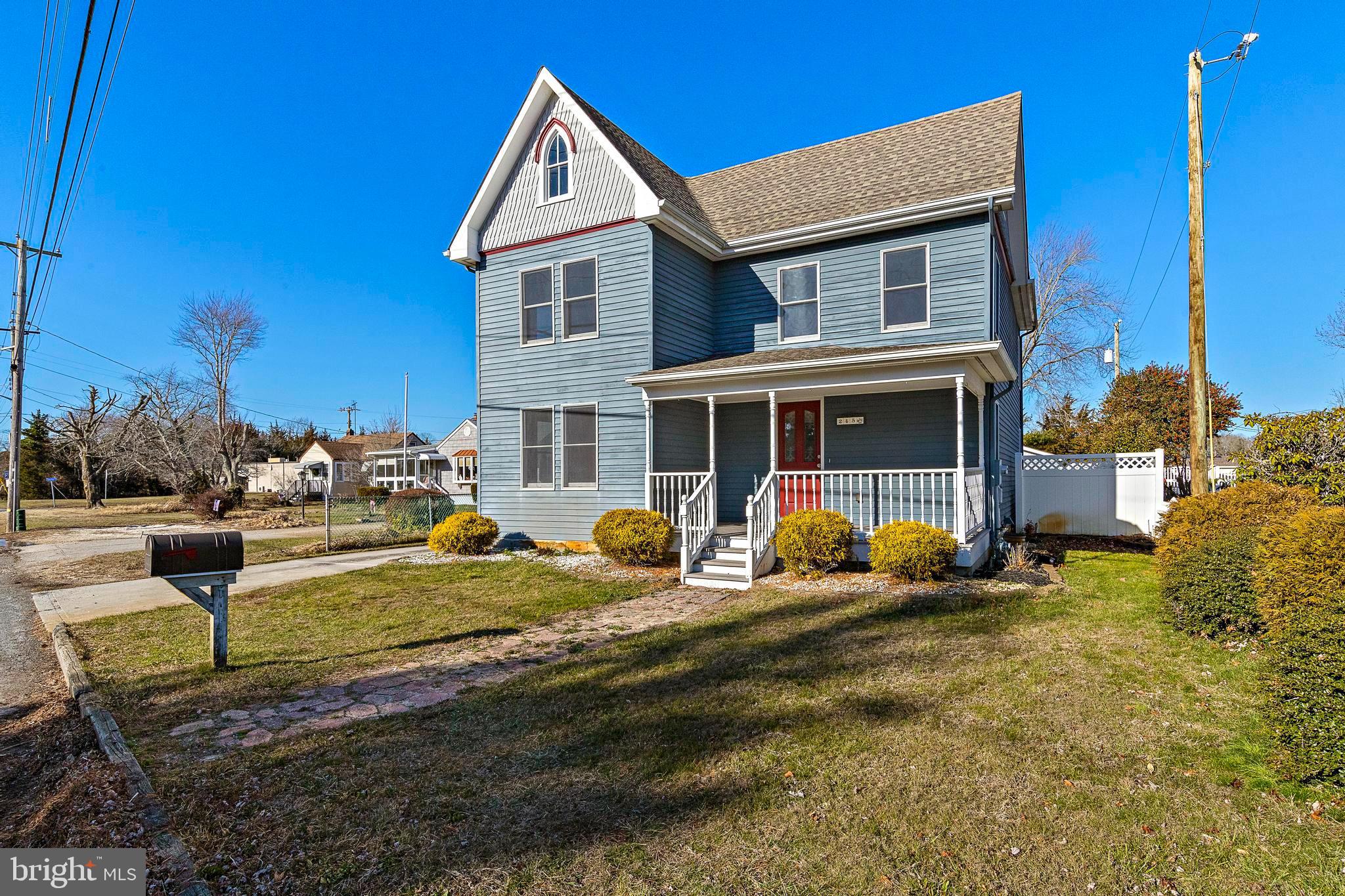 a front view of a house with garden and porch