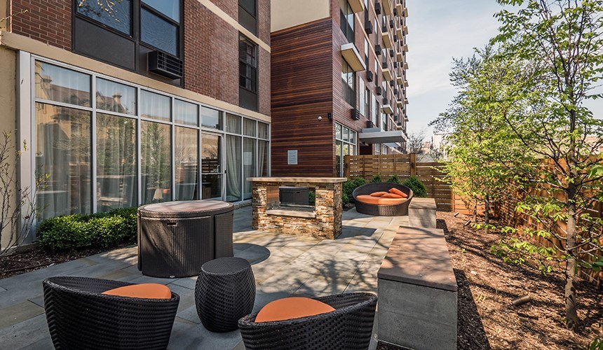 a view of an outdoor sitting area with brick walls