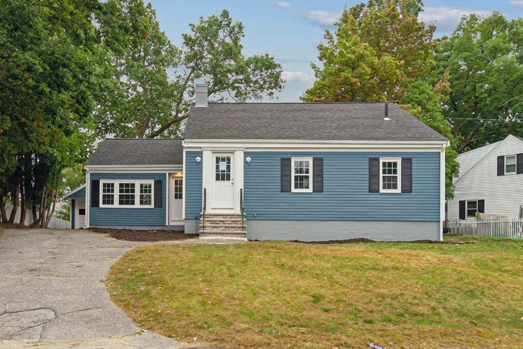 a front view of a house with a garden