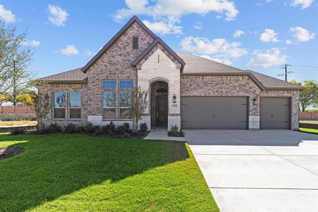 a front view of a house with a yard