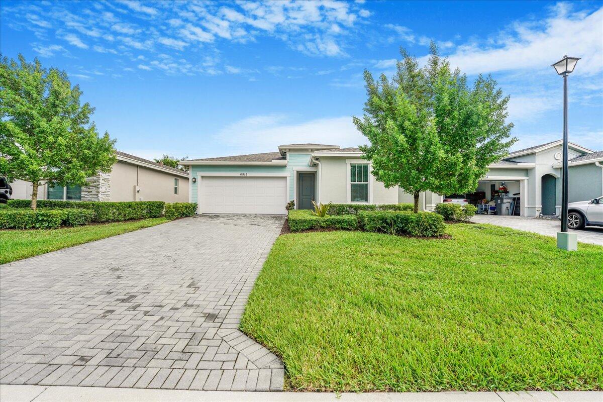 a front view of a house with a yard and garage