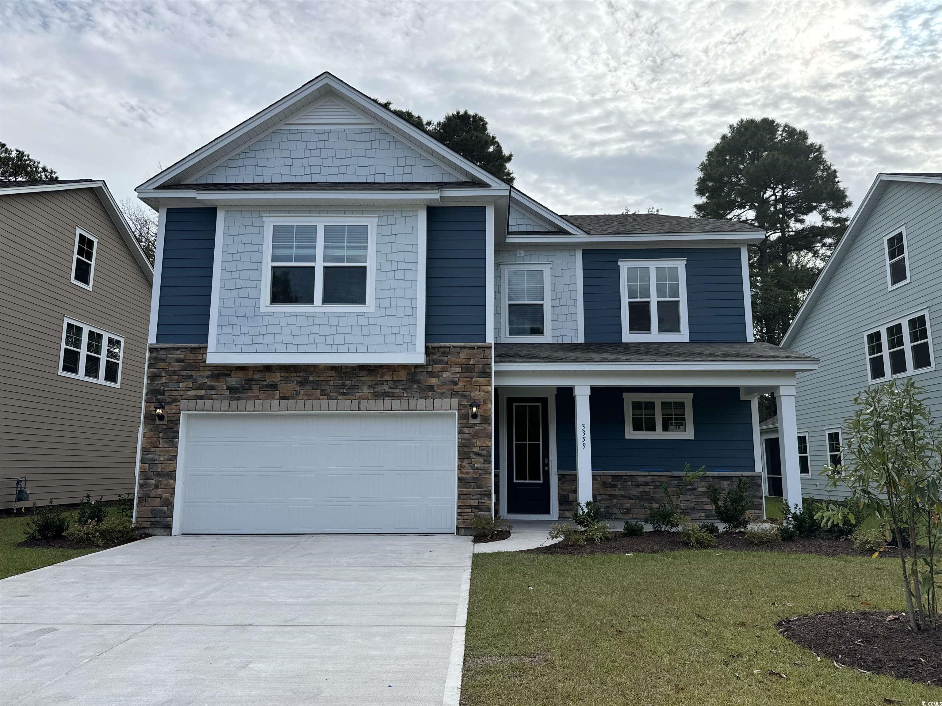 Craftsman inspired home with a garage and a front