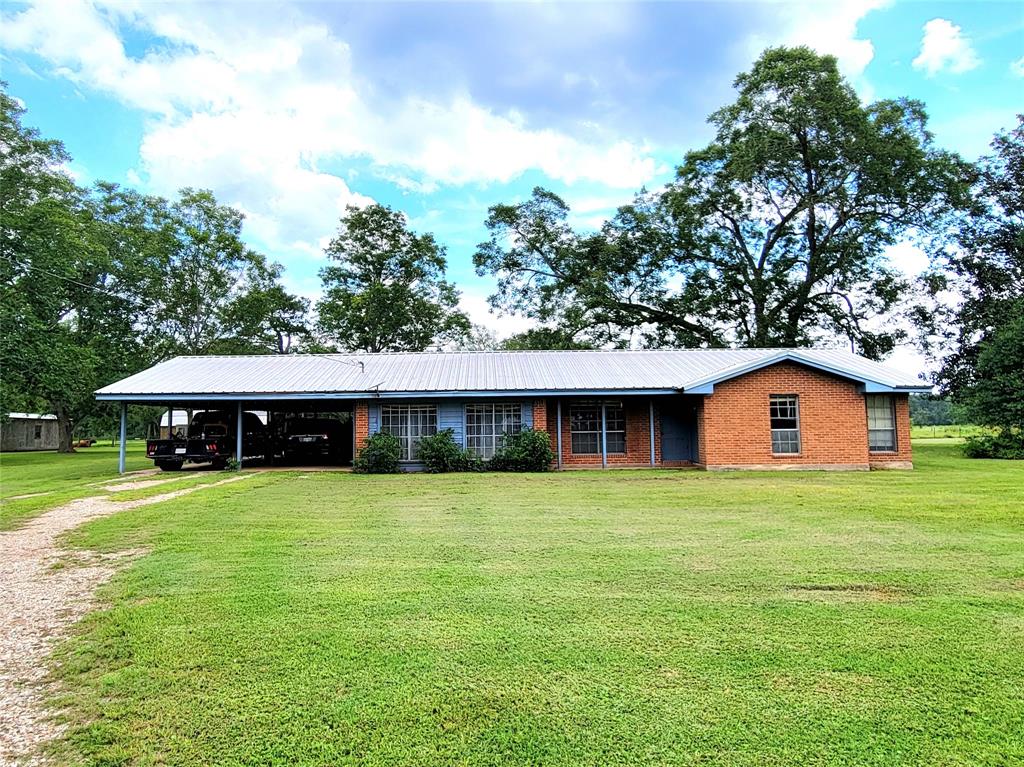 a front view of house with yard and trees