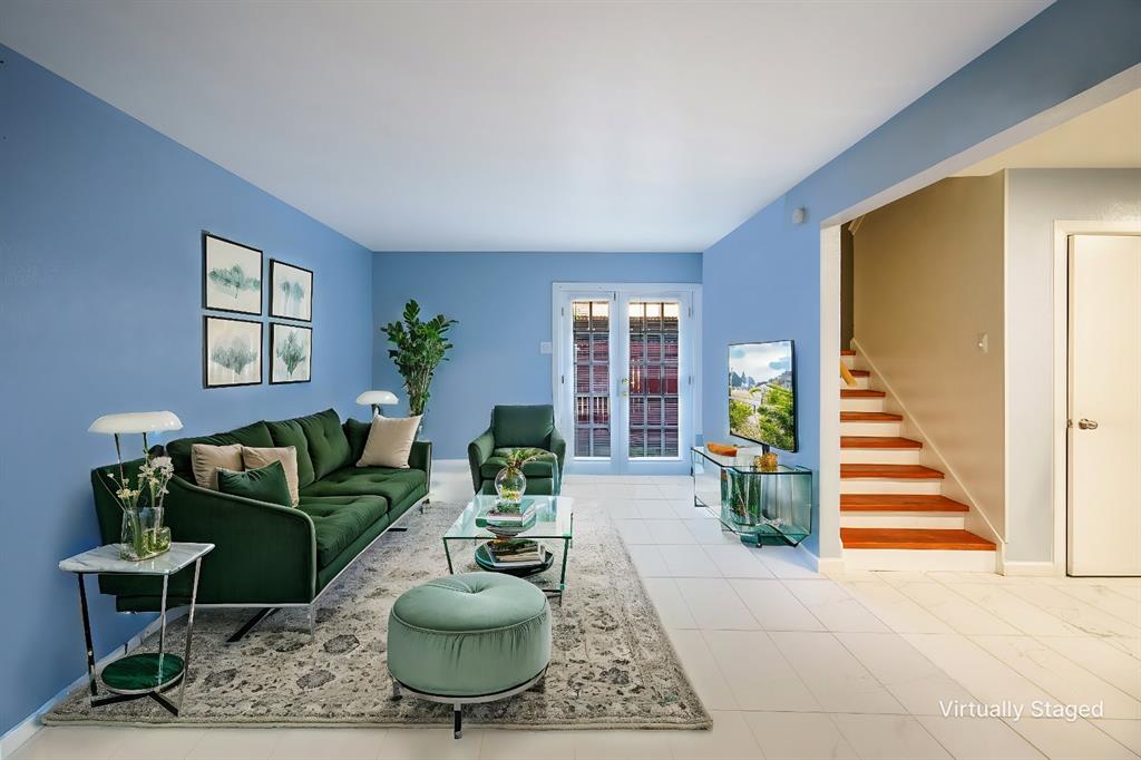 a living room with furniture and a potted plant