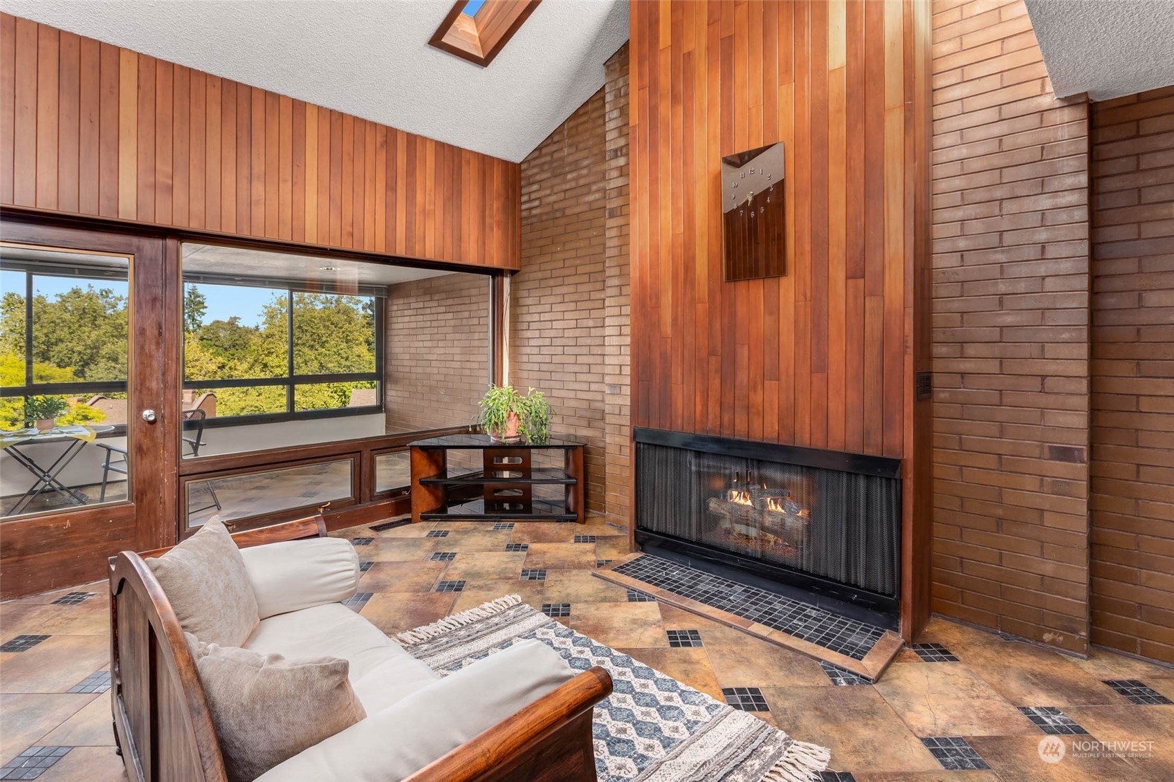 a living room with furniture a fireplace and a window