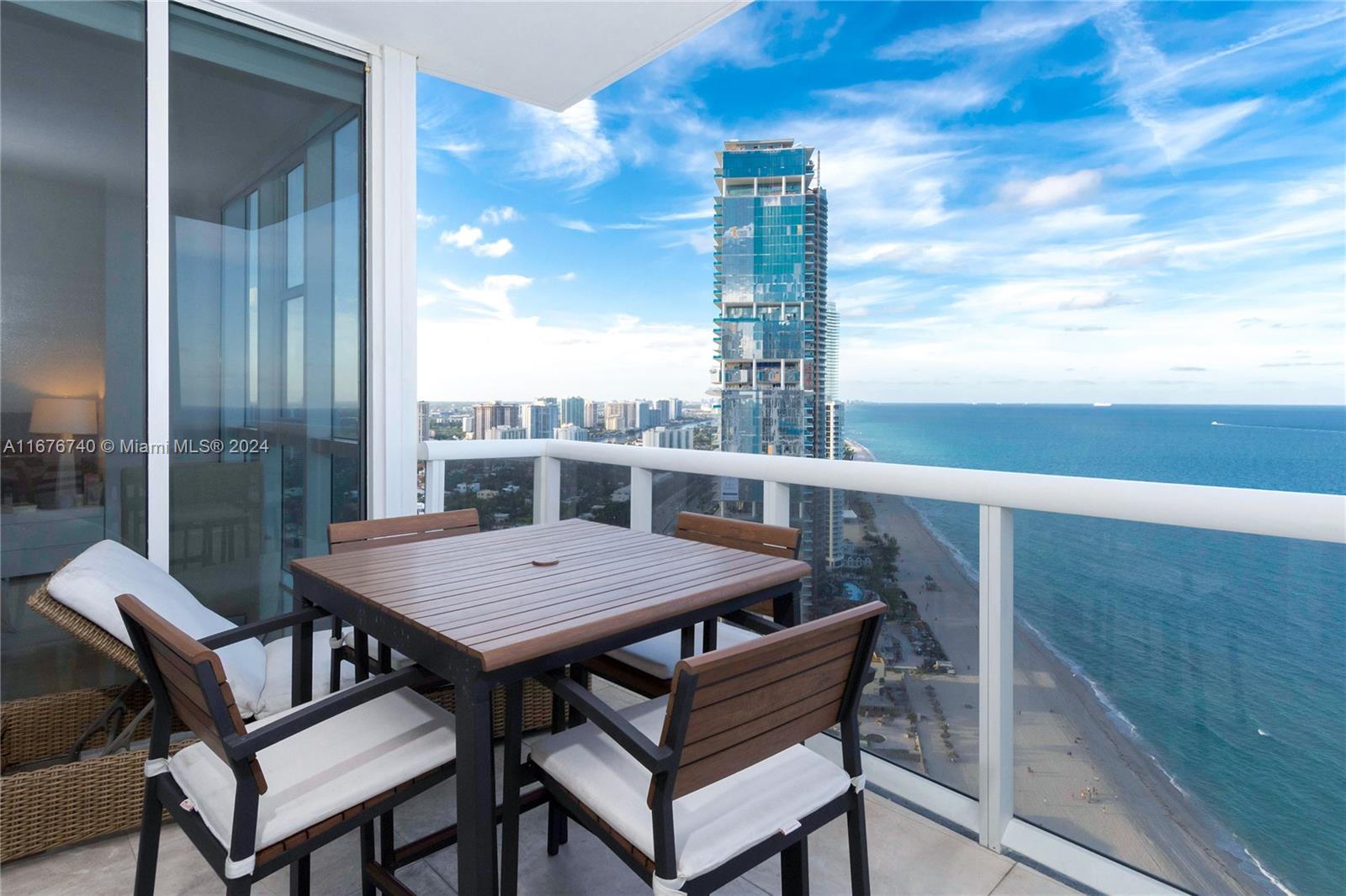 a view of a balcony with table and chairs