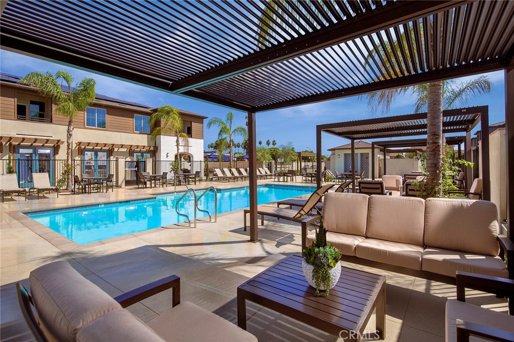 a view of a patio with couches table and chairs with wooden floor