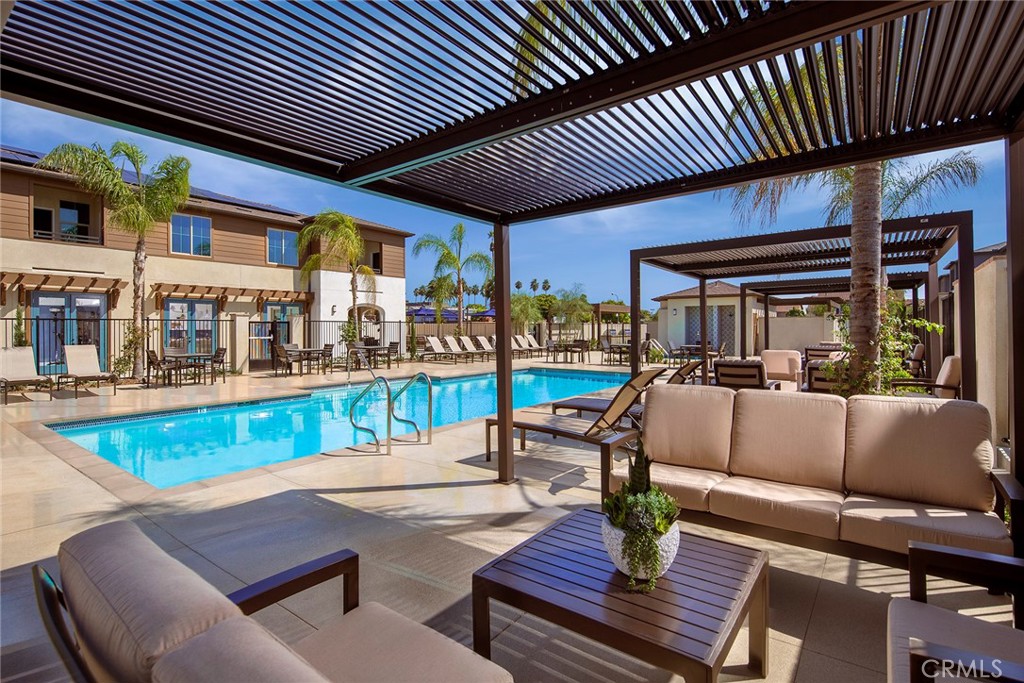 a view of a patio with couches table and chairs with wooden floor