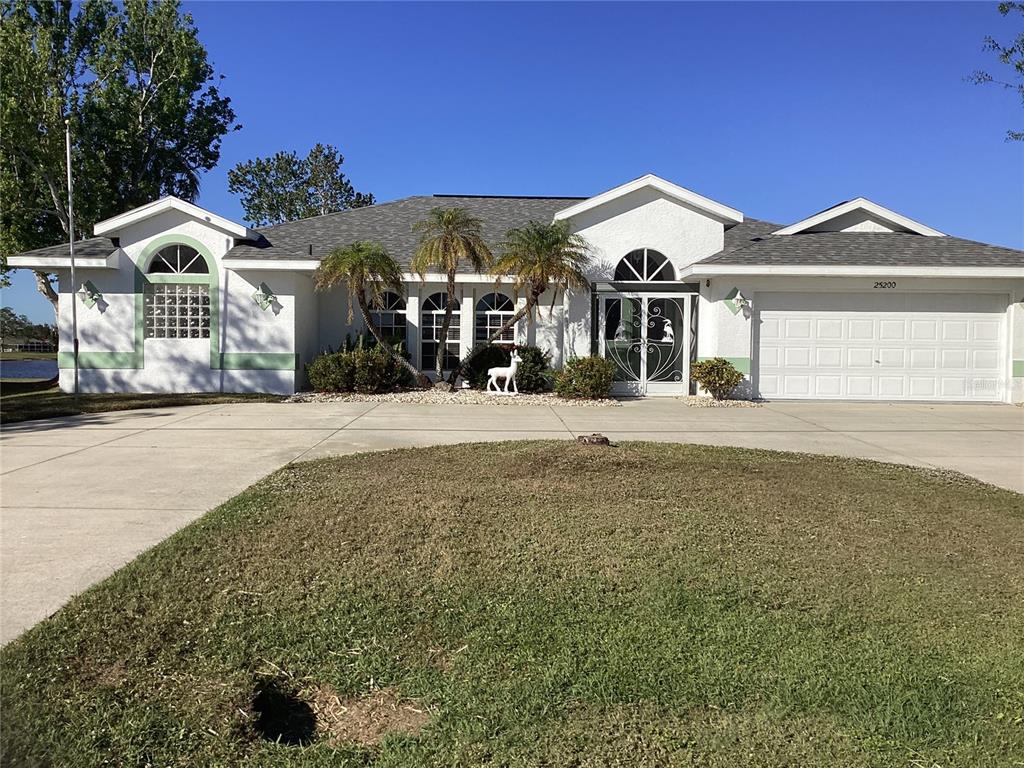 a front view of a house with a yard and garage