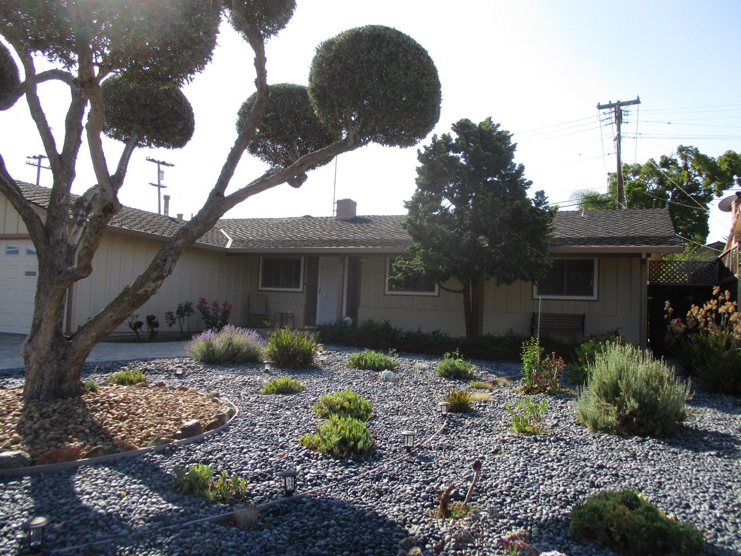 a front view of a house with garden