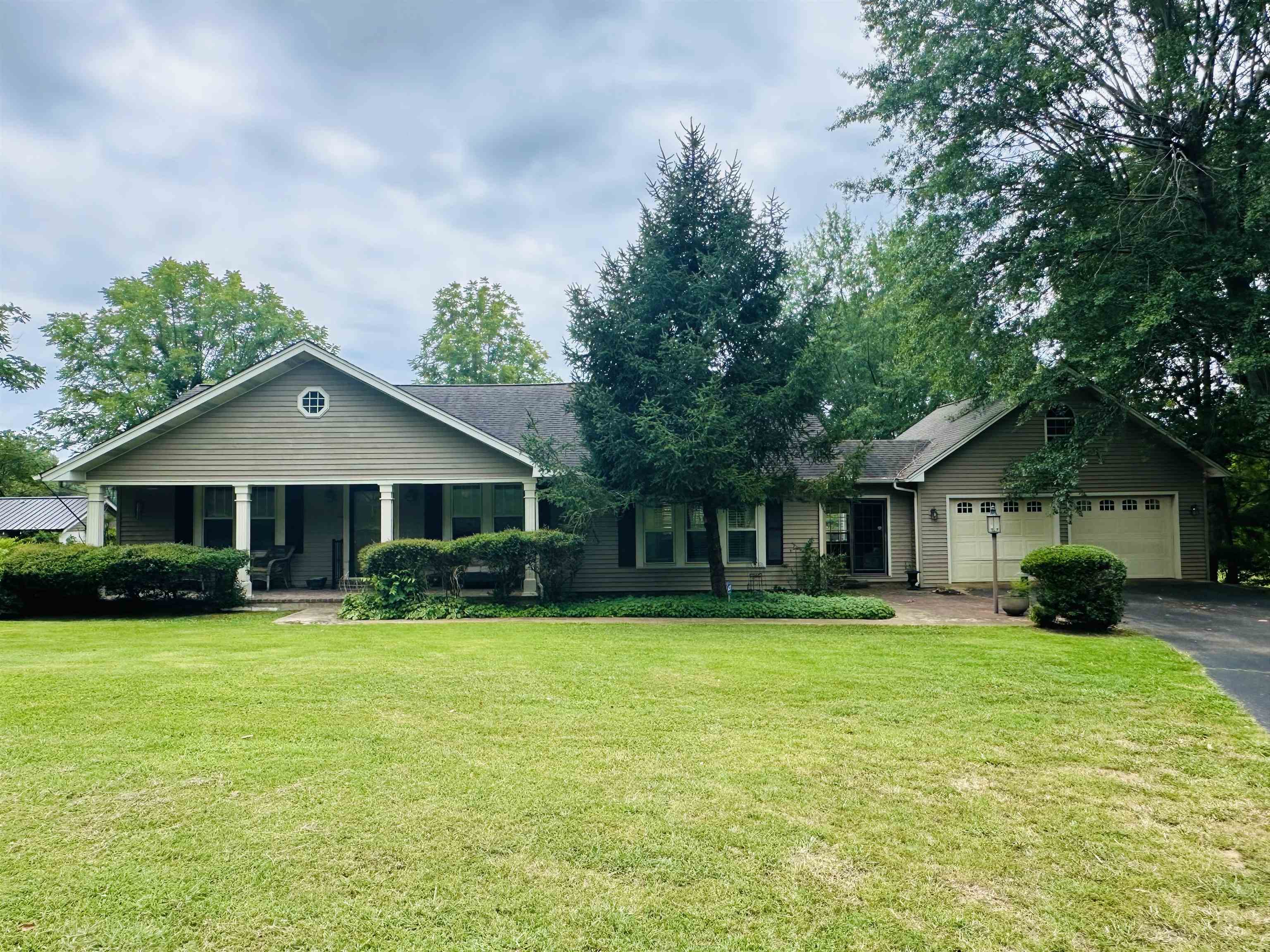 a front view of house with yard and green space