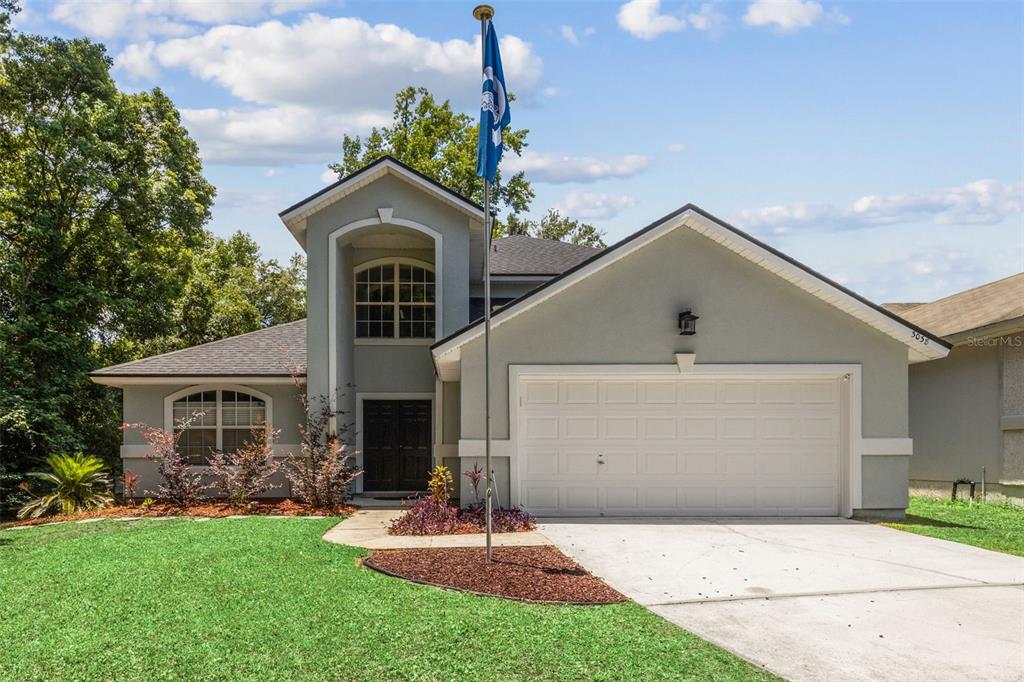 a front view of a house with a yard