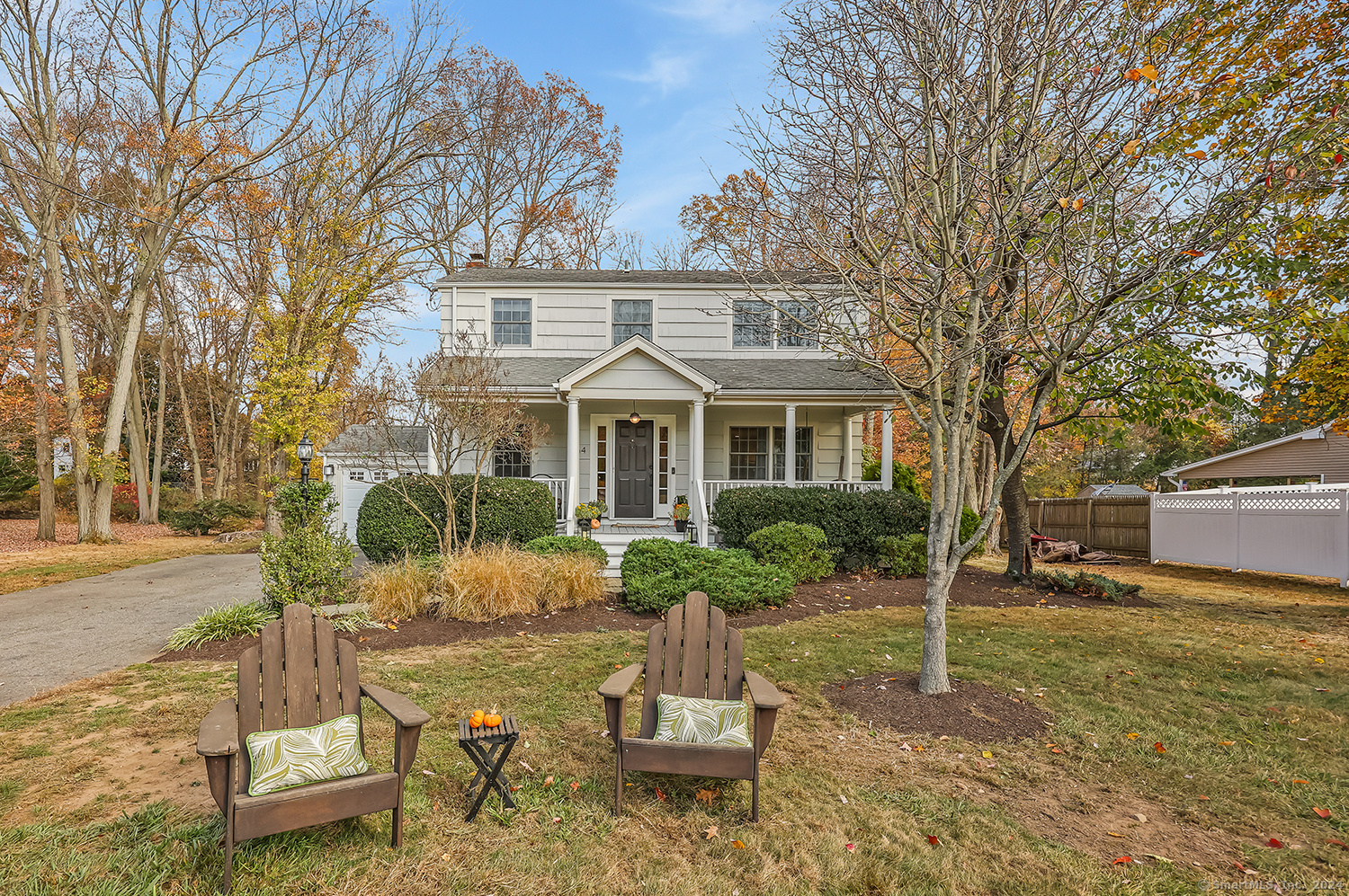 a front view of a house with a yard garage and outdoor seating