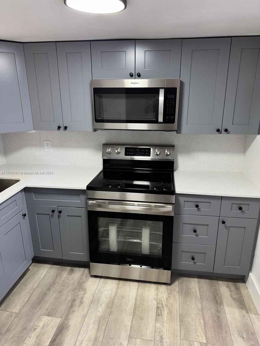 a kitchen with granite countertop a stove and a sink