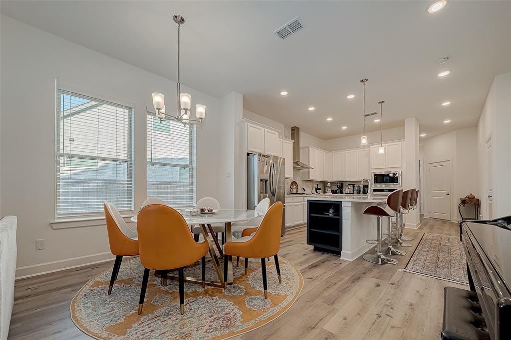 a view of a dining room with furniture and wooden floor