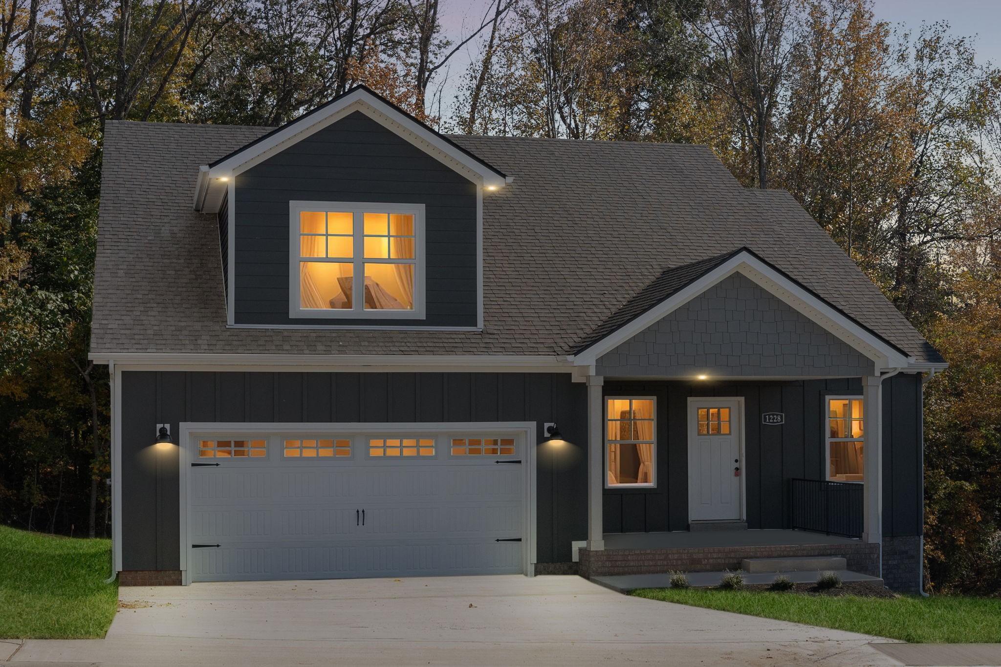 a front view of a house with a yard and garage