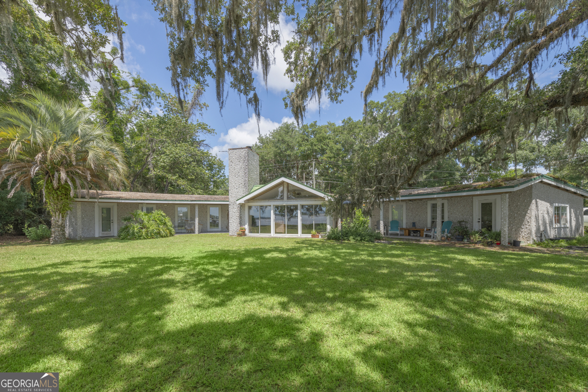 a front view of house with yard and green space