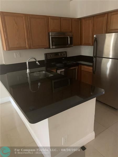 a kitchen with a sink and stainless steel appliances