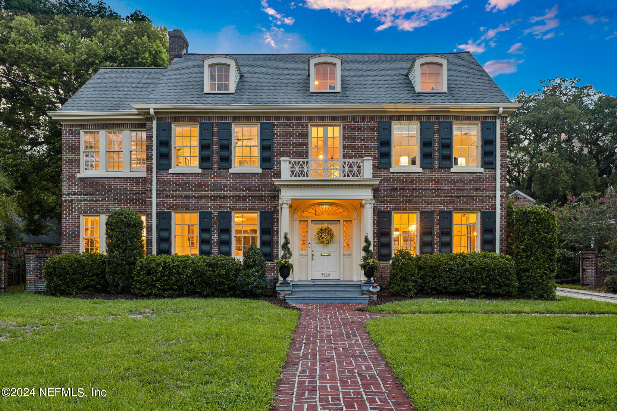 a front view of a house with garden