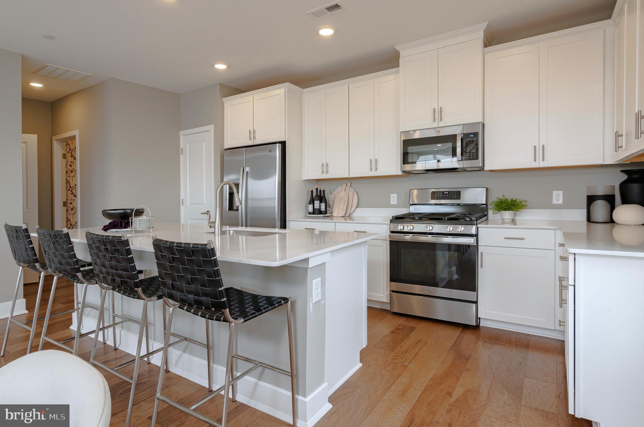 a kitchen with a stove a sink and a refrigerator