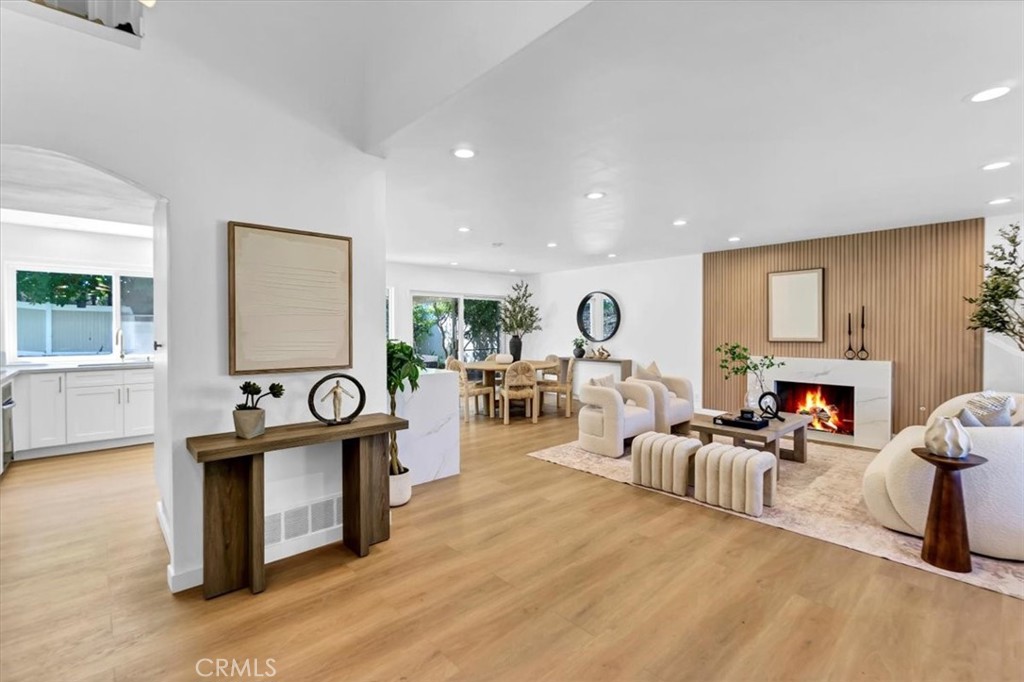 a living room with furniture a fireplace and a table