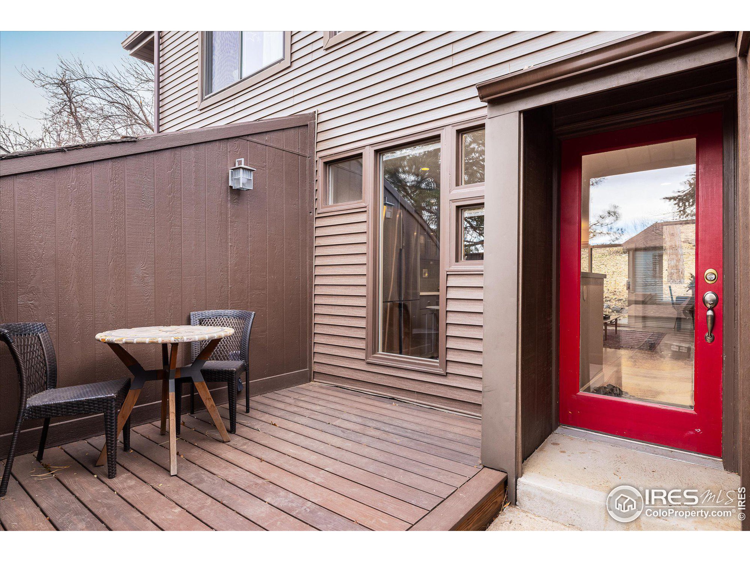 a view of a wooden bench sitting in front of a house