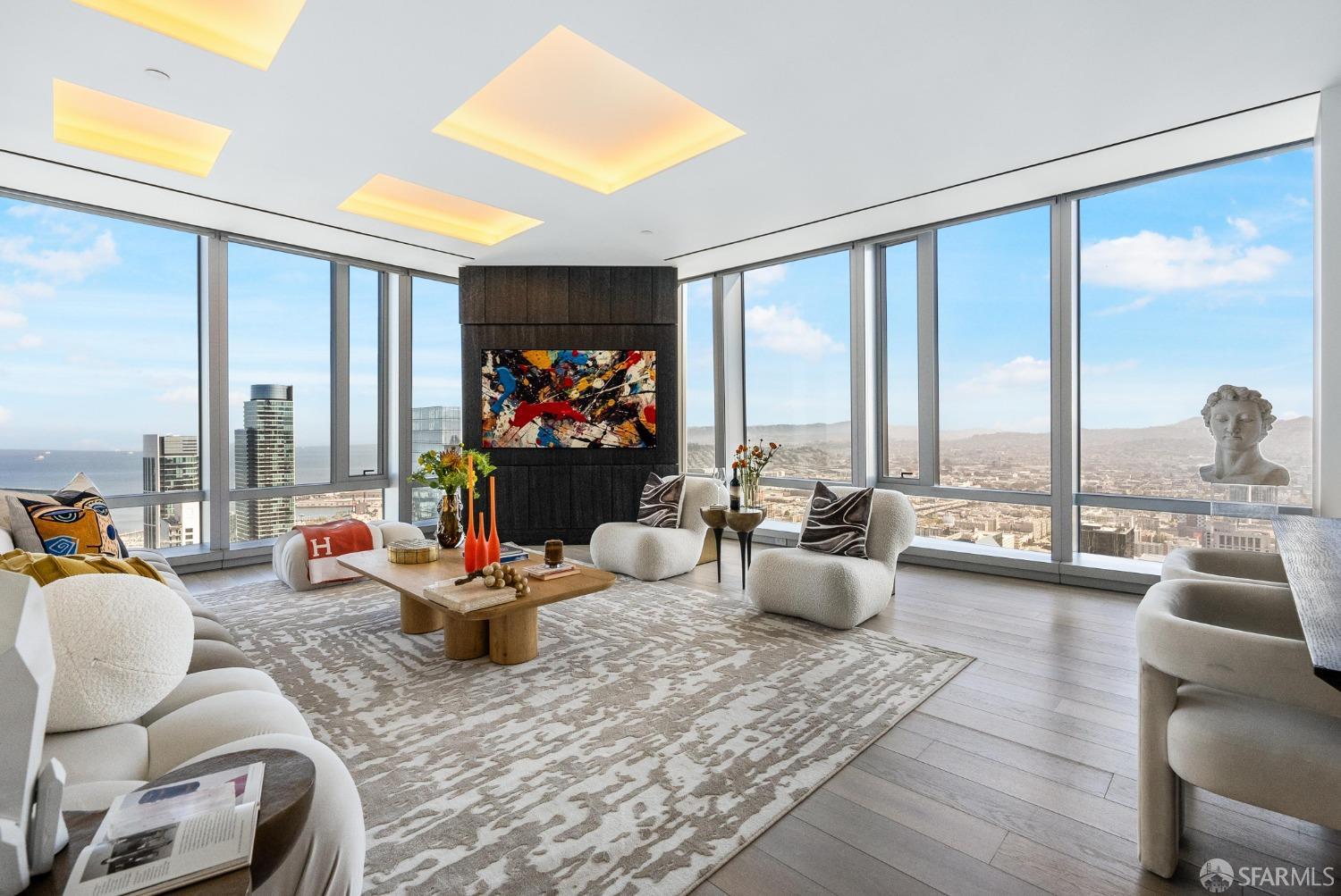 a living room with furniture and floor to ceiling windows