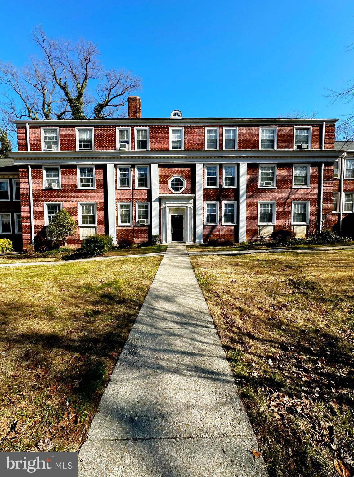 a front view of a residential apartment building with a yard