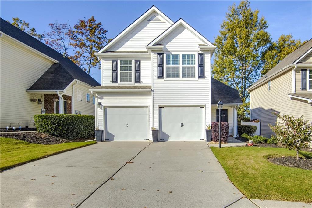 a front view of a house with a yard and garage