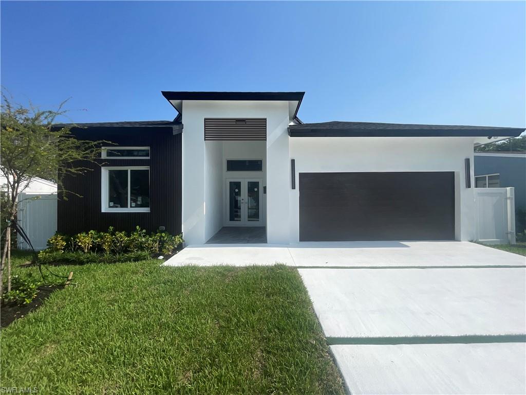 a front view of a house with a yard and garage