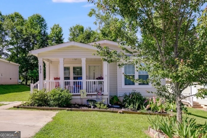 a front view of a house with a yard and porch