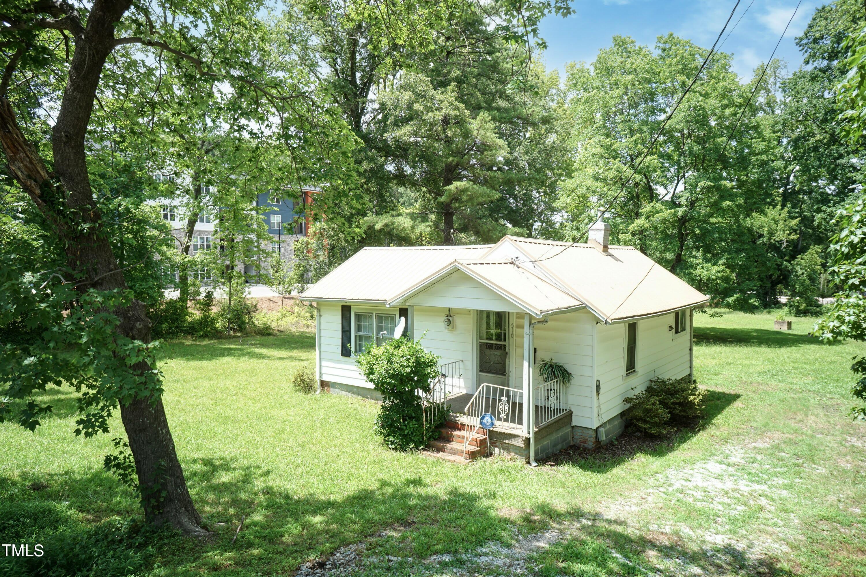 a view of a house with a yard and sitting area