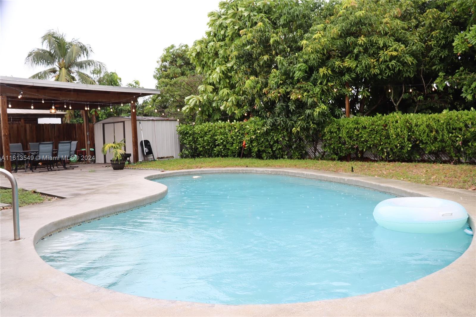 a view of a swimming pool with an outdoor seating