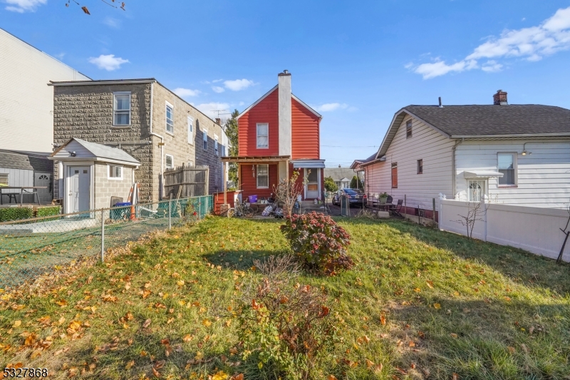 a view of a house with a big yard and potted plants