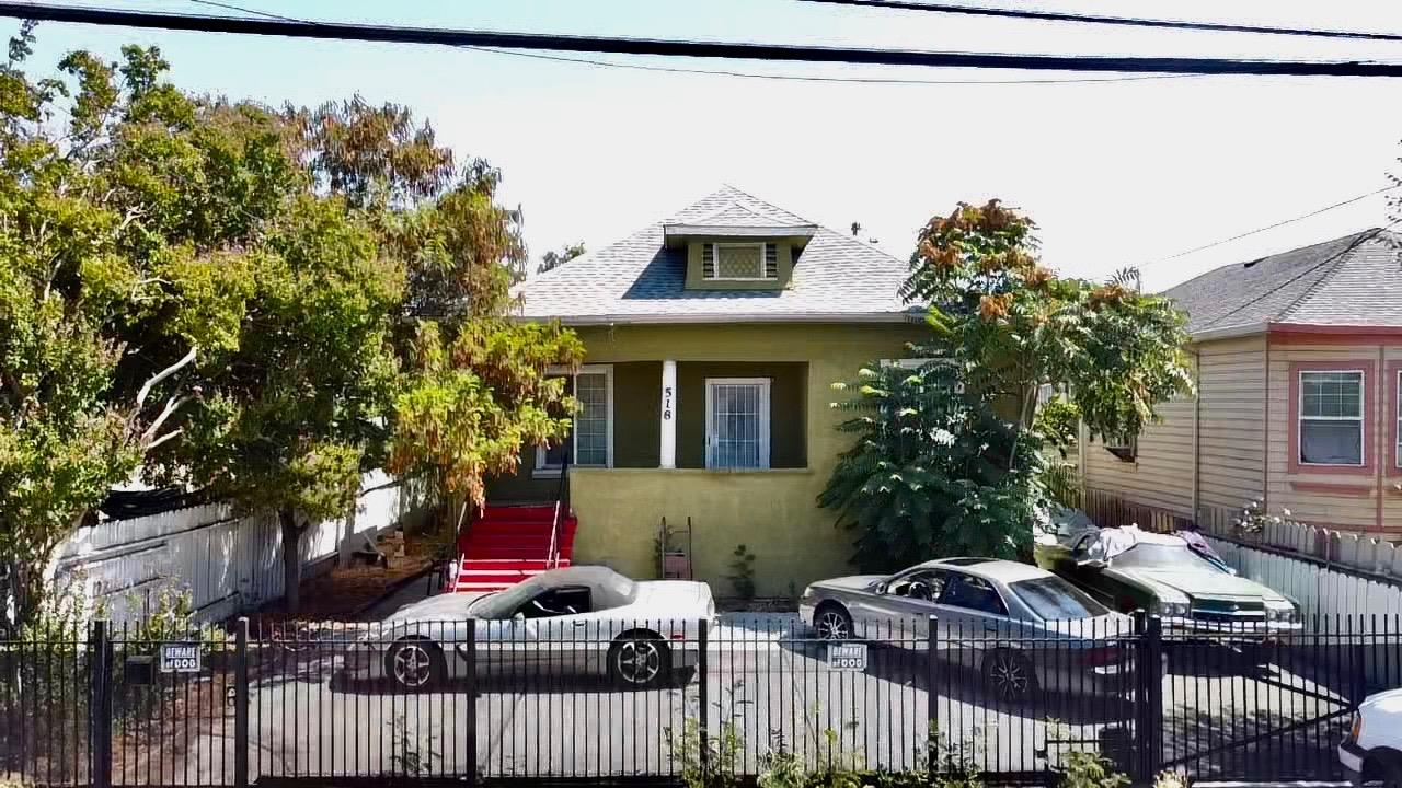 a front view of a house with a tree