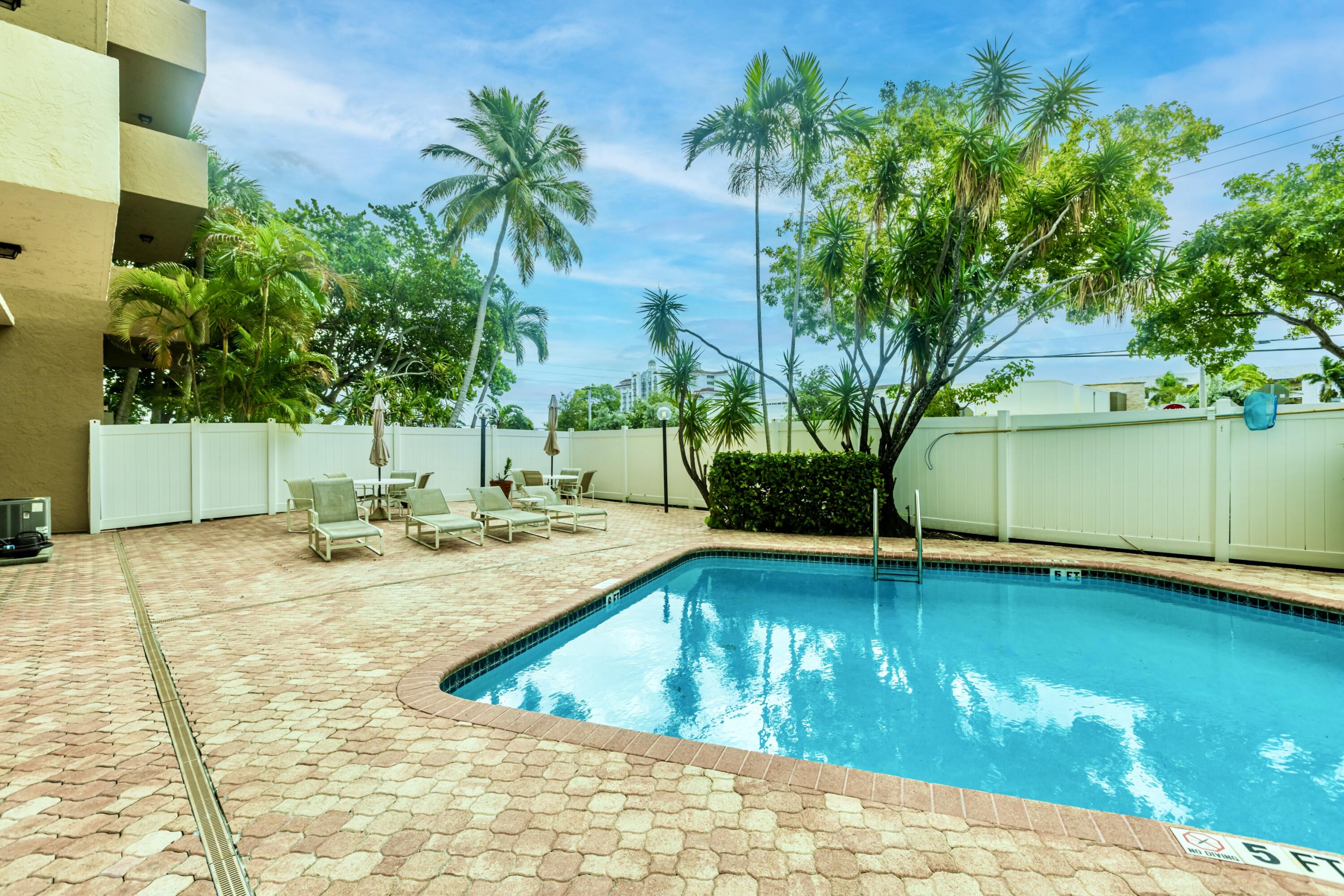 a view of a swimming pool with an outdoor space and seating area