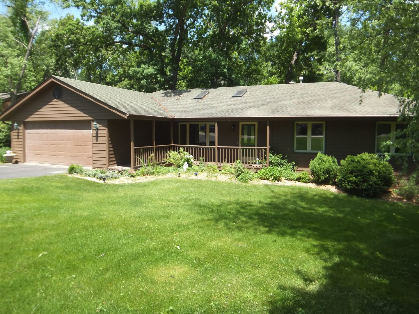 a front view of house with a garden and yard