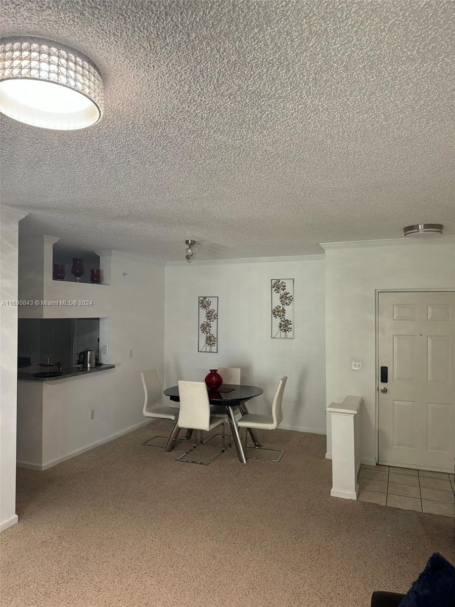 a living room with furniture a flat screen tv and white walls