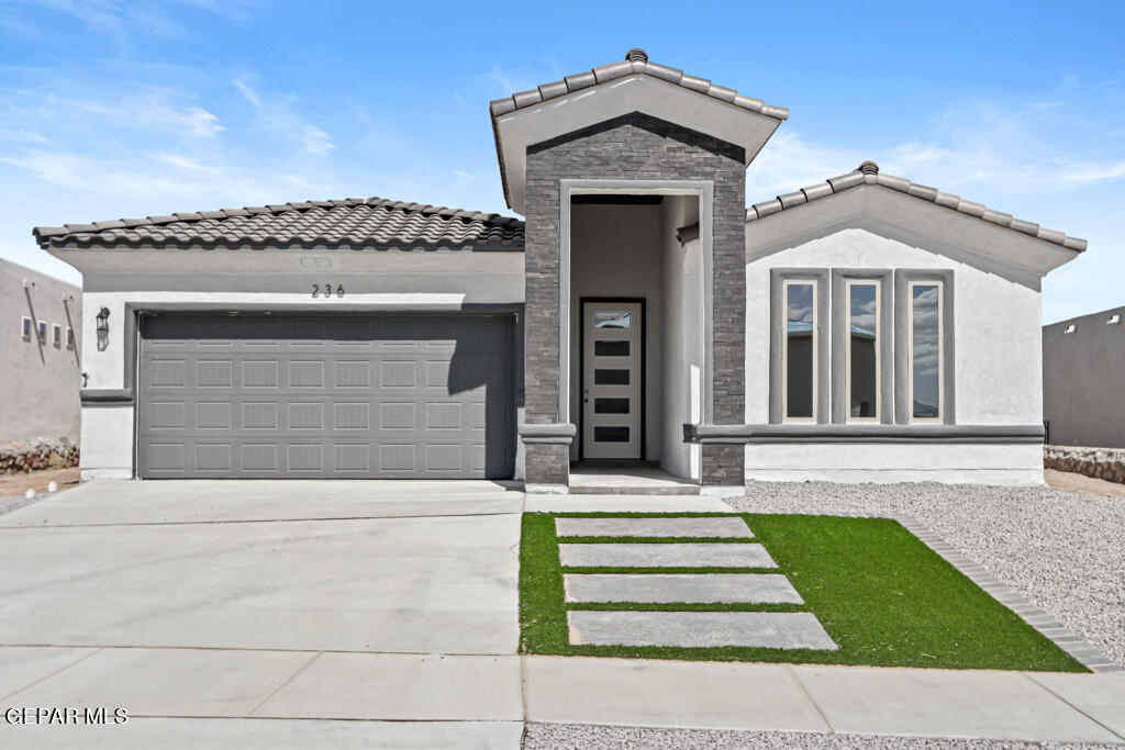 a front view of a house with a small garden