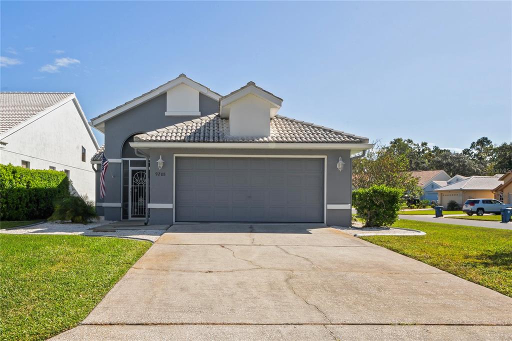 a front view of a house with a yard and garage