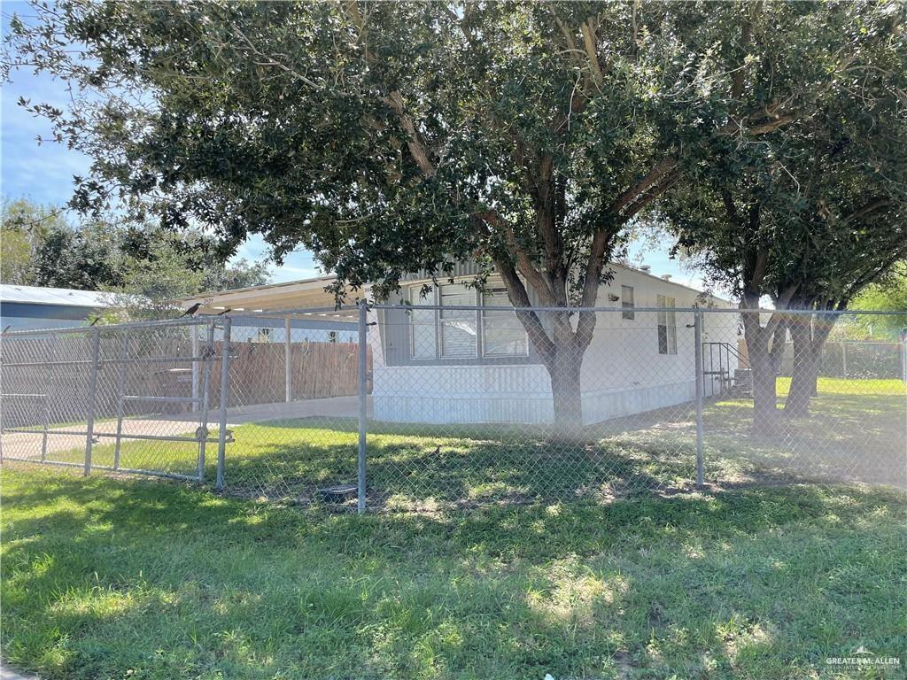 a view of a tree in front of a yard