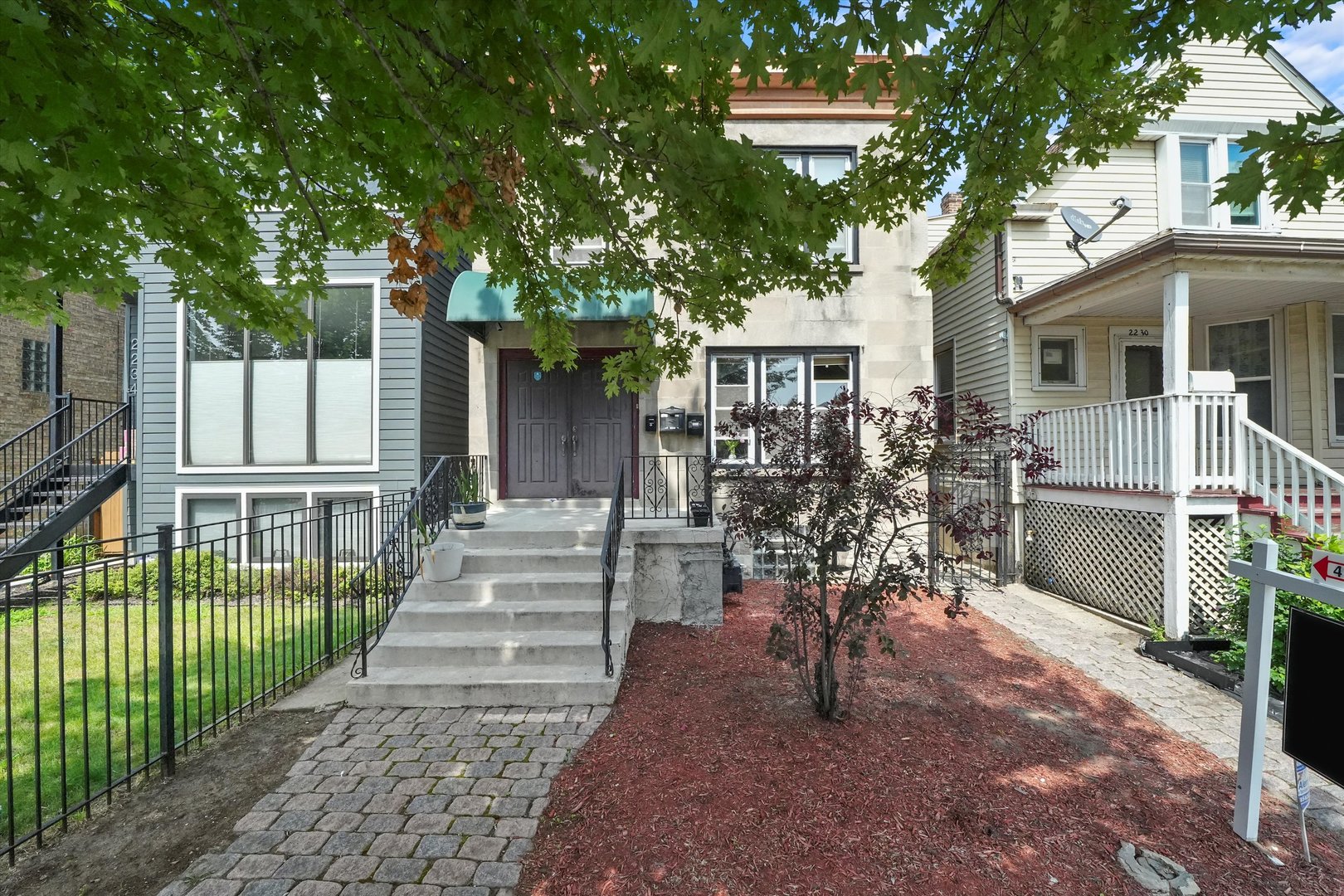 a view of house with patio outdoor seating and trees