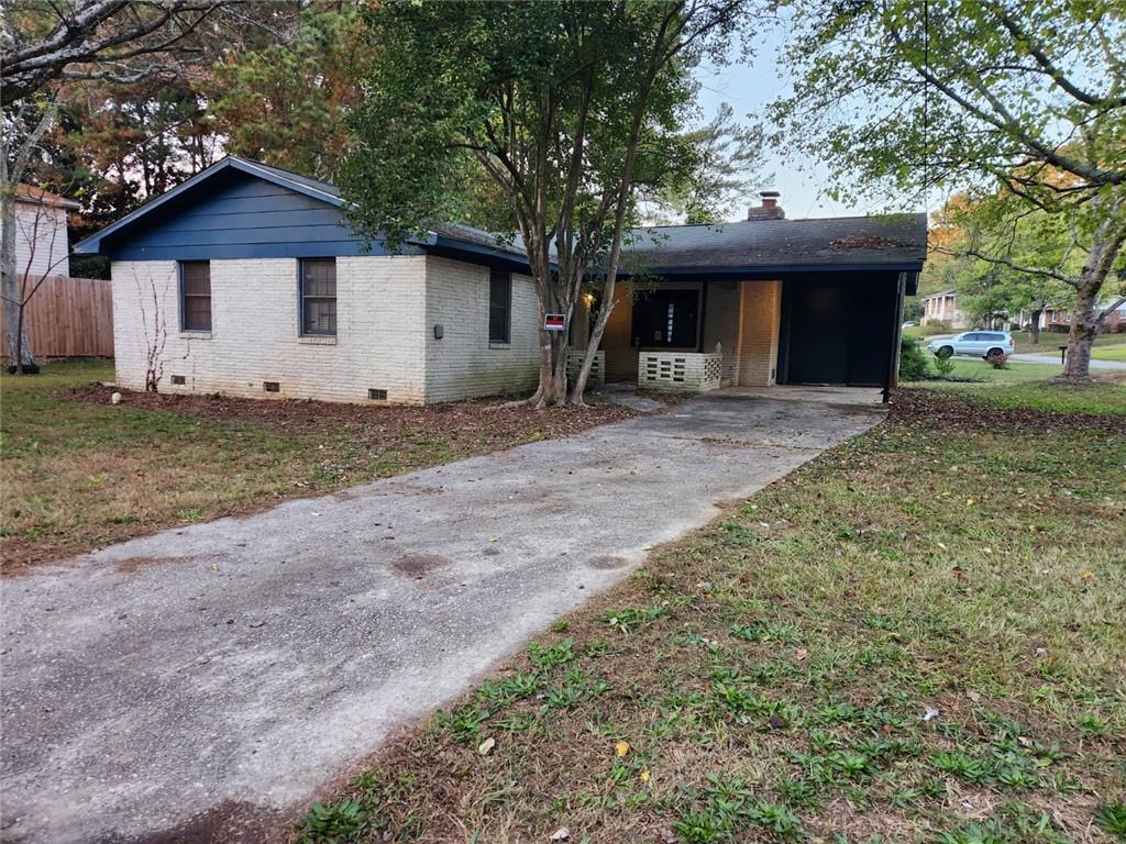 a front view of house with yard and trees