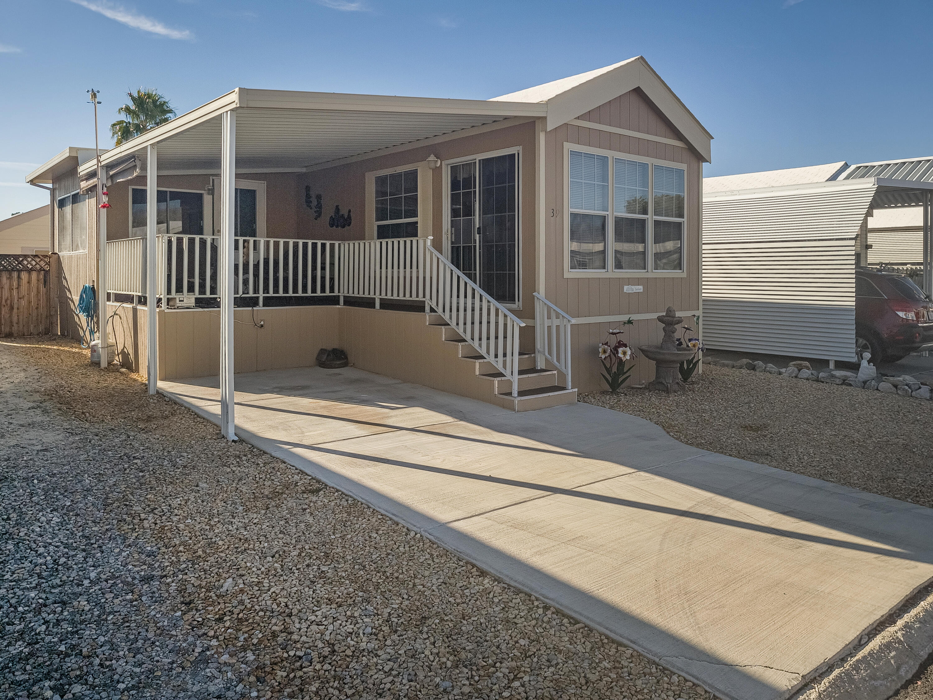 a view of a house with a small yard and wooden fence